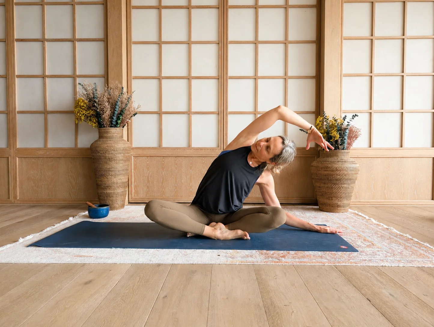 Anat practicing yoga on a mat